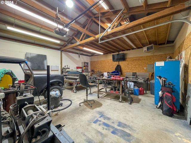 garage with a workshop area and a garage door opener