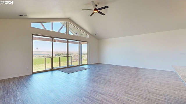 unfurnished living room with hardwood / wood-style flooring, ceiling fan, and vaulted ceiling