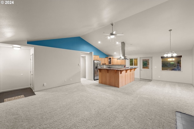 kitchen featuring island exhaust hood, stainless steel fridge with ice dispenser, a breakfast bar area, vaulted ceiling, and light colored carpet