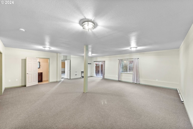 interior space with a textured ceiling and a baseboard heating unit