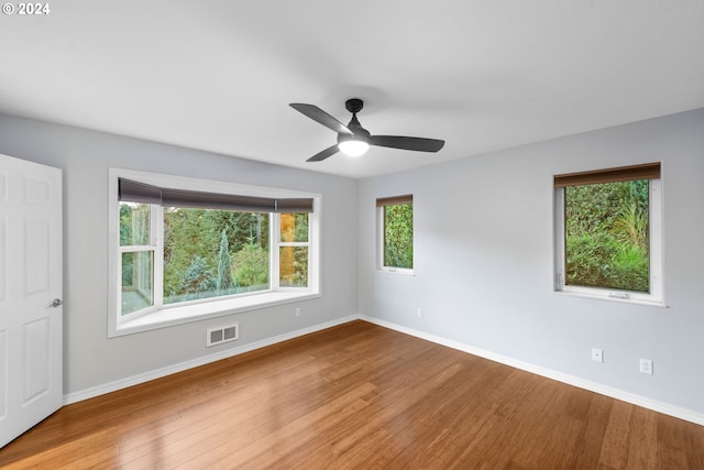 unfurnished room with ceiling fan and wood-type flooring