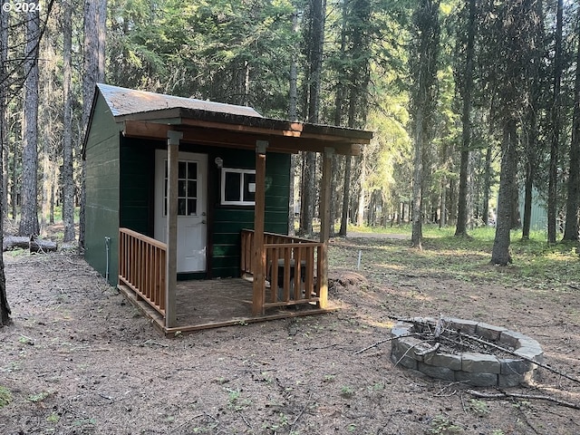 view of outbuilding featuring an outdoor fire pit