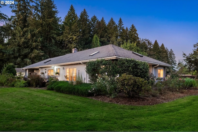 22750 SW Rosedale Rd, Beaverton, OR 97078 - rear view of house with a lawn, a chimney, and a tile roof