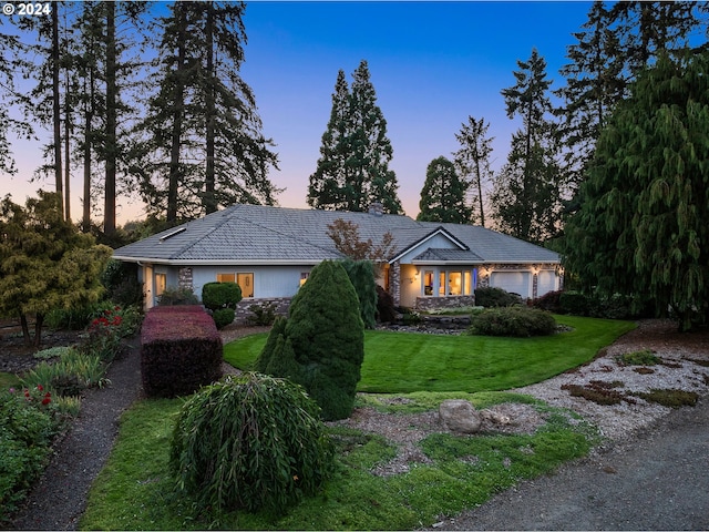 22750 SW Rosedale Rd, Beaverton, OR 97078 - view of front of house with stone siding, a garage, a front yard, a tile roof, and stucco siding