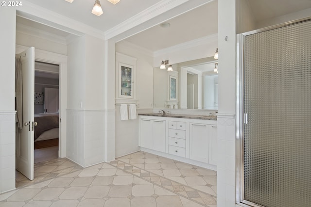 bathroom featuring crown molding, vanity, tile walls, and a shower with door