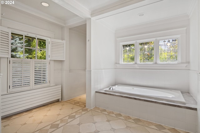 bathroom with tile patterned flooring, plenty of natural light, tiled bath, and ornamental molding