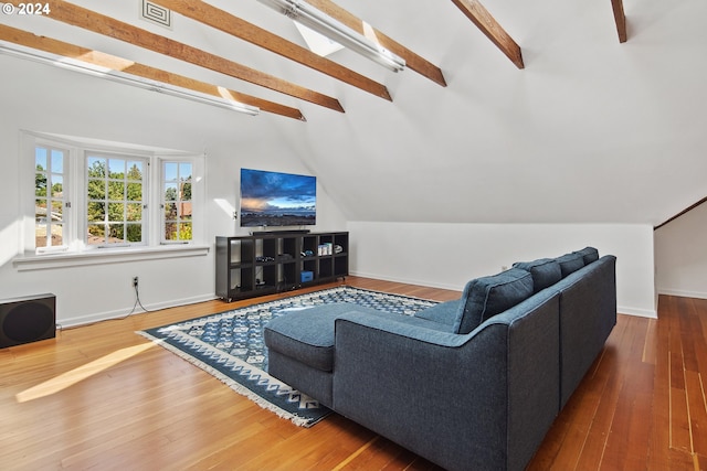 living room featuring lofted ceiling with beams and hardwood / wood-style flooring