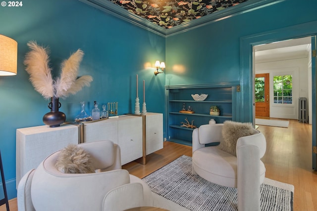 living room with crown molding and hardwood / wood-style flooring