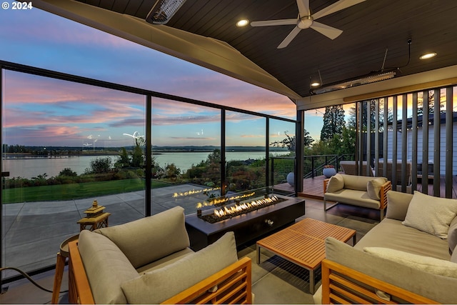 sunroom / solarium with a water view, vaulted ceiling, ceiling fan, and wood ceiling