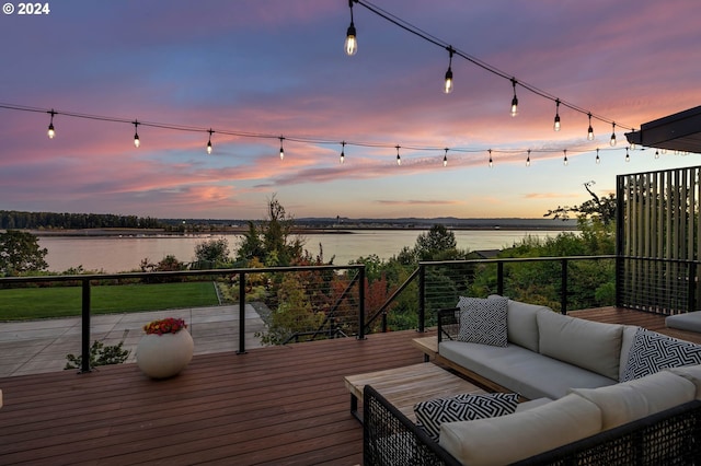 deck at dusk featuring a water view and an outdoor hangout area