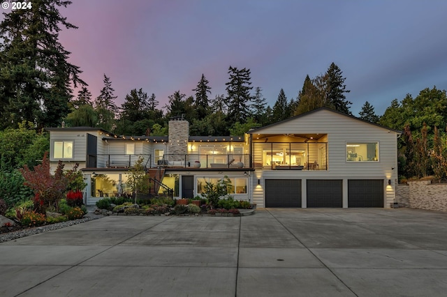 view of front facade with a balcony and a garage