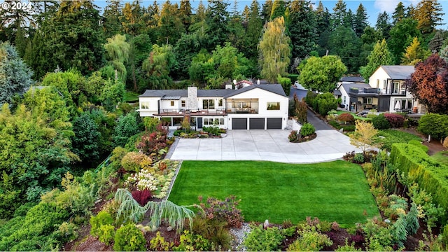 back of property featuring a lawn and a garage