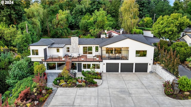 view of front of property featuring a garage and a deck