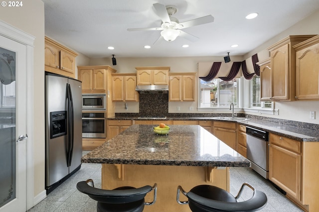 kitchen featuring a kitchen breakfast bar, a center island, and stainless steel appliances