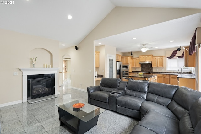 living room with ceiling fan, sink, and high vaulted ceiling