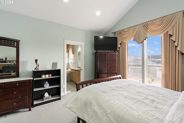 carpeted bedroom featuring ensuite bathroom and lofted ceiling