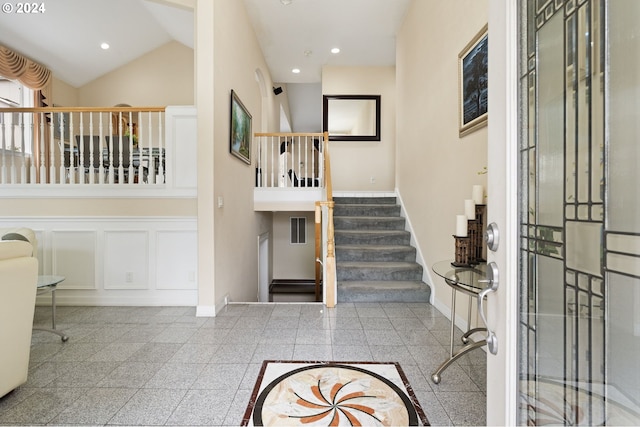 entrance foyer featuring high vaulted ceiling