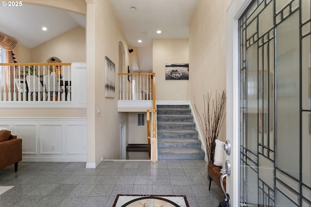 foyer with granite finish floor, stairs, baseboards, and recessed lighting