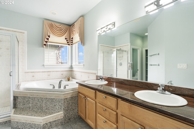 bathroom with vanity and shower with separate bathtub