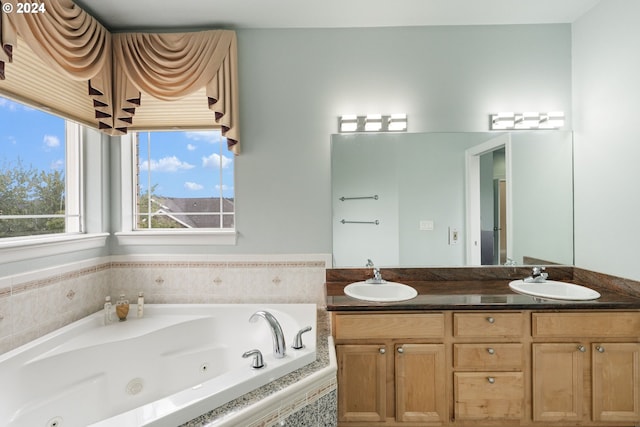 bathroom with vanity and tiled bath