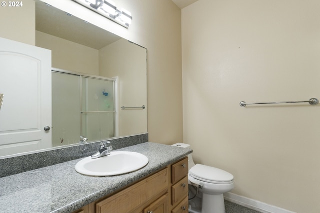 bathroom with walk in shower, vanity, and toilet