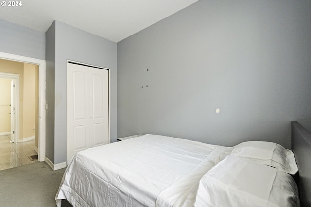 carpeted bedroom with a closet