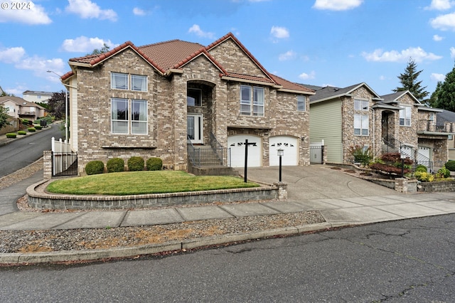 view of front of house with a garage and a front lawn