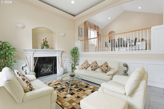 living room featuring high vaulted ceiling and a tiled fireplace