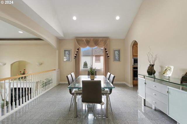 dining room with crown molding and lofted ceiling