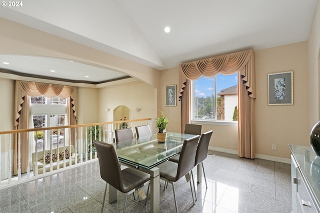 dining area with lofted ceiling and ornamental molding