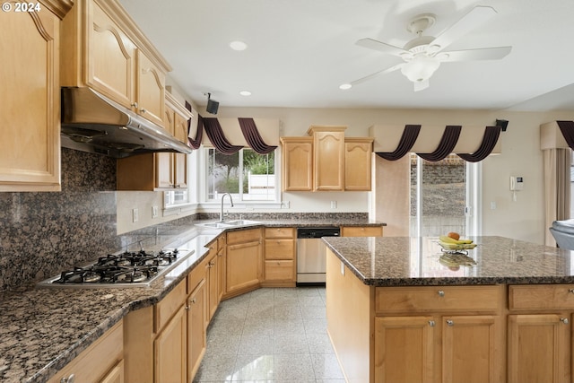 kitchen featuring light brown cabinetry, sink, a kitchen island, and stainless steel appliances