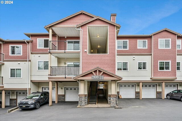 view of front facade featuring a garage and a balcony