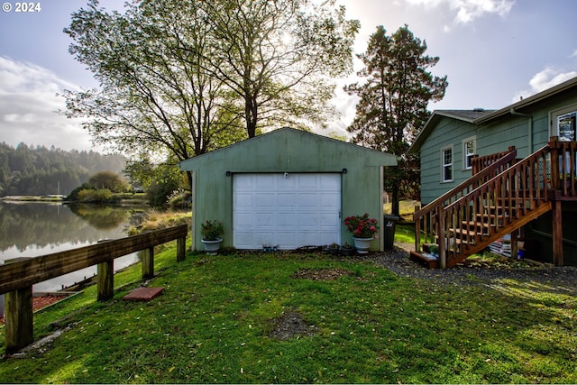 garage with a yard and a water view