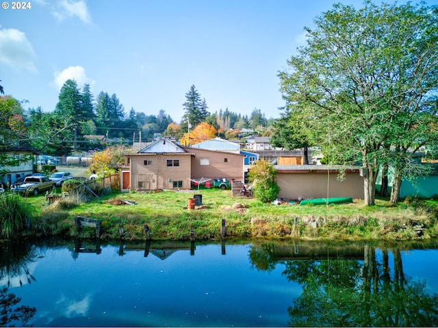 rear view of property with a water view