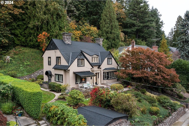 1709 NW Aspen Ave, Portland, OR 97210 - view of front of house featuring fence, a patio, stucco siding, and a chimney