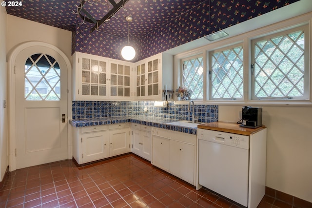 1709 NW Aspen Ave, Portland, OR 97210 - kitchen with dark countertops, dishwasher, a sink, white cabinets, and glass insert cabinets