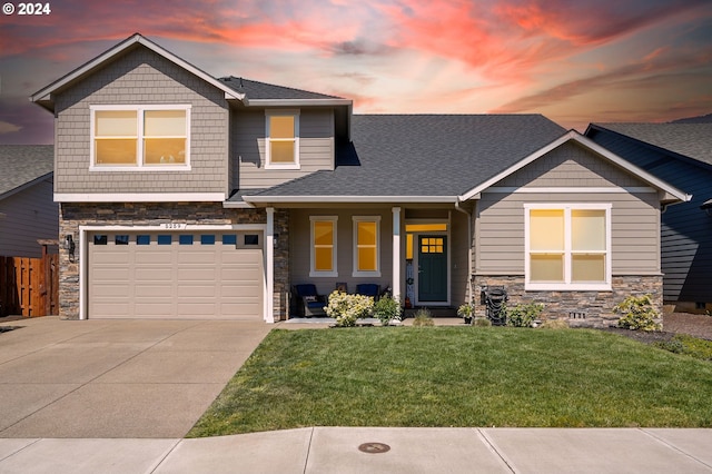 craftsman-style home with a yard and a garage