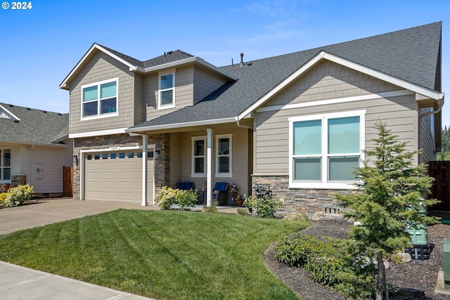 craftsman-style house featuring a front lawn and a garage