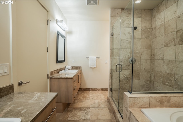 bathroom with visible vents, baseboards, a tub to relax in, vanity, and a stall shower