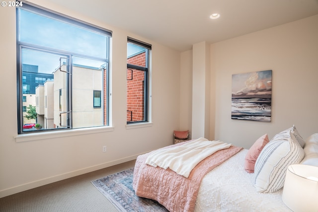carpeted bedroom featuring recessed lighting and baseboards