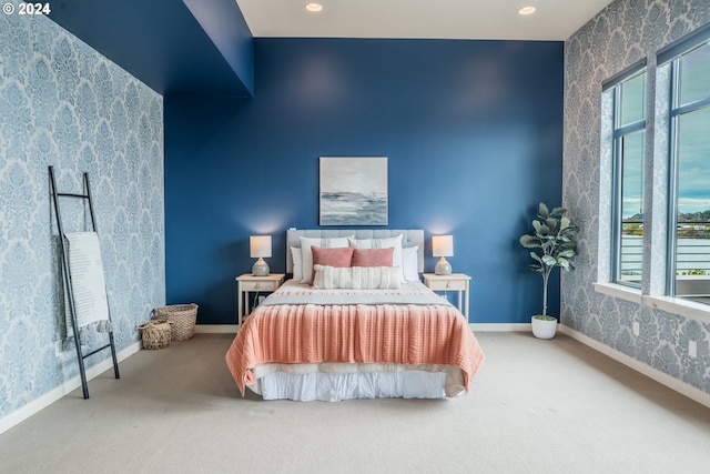 carpeted bedroom with wallpapered walls, baseboards, and recessed lighting