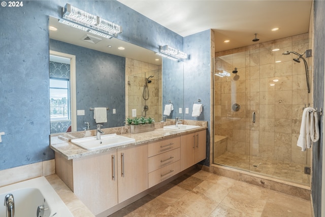 bathroom with double vanity, visible vents, a sink, and a stall shower