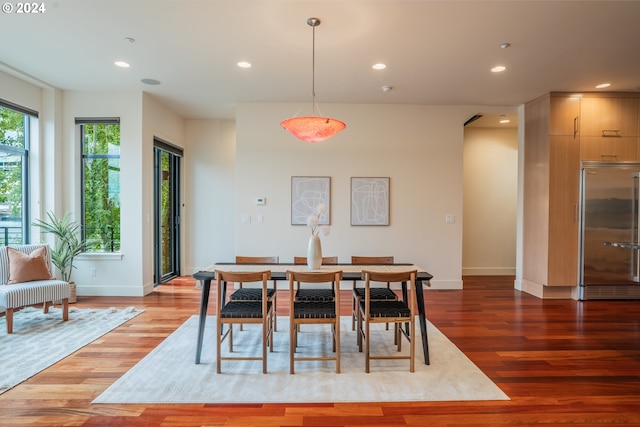 dining area featuring wood finished floors, baseboards, and recessed lighting