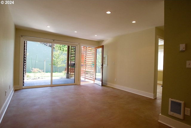 unfurnished room featuring heating unit