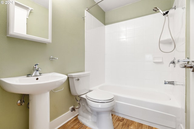 bathroom featuring shower / tub combination, toilet, and wood-type flooring