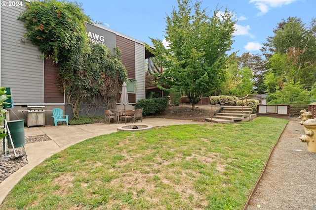 view of yard featuring a patio and a fire pit