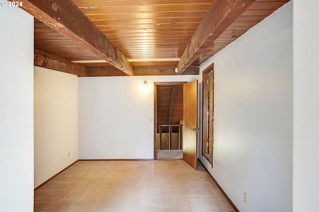 empty room featuring wooden ceiling and beam ceiling