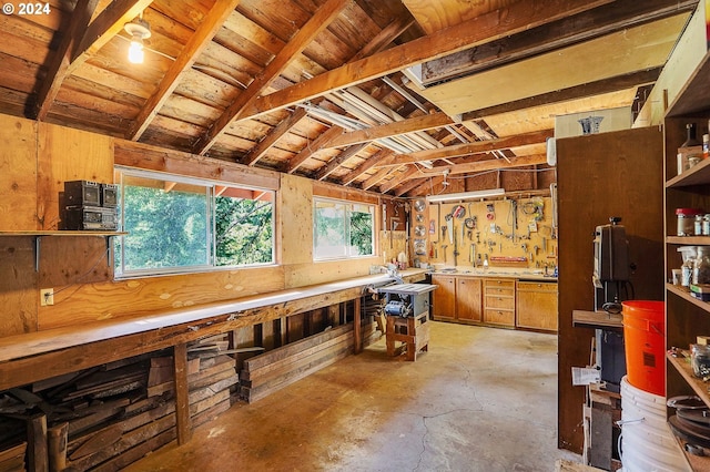 miscellaneous room featuring lofted ceiling with beams, a workshop area, and wooden ceiling