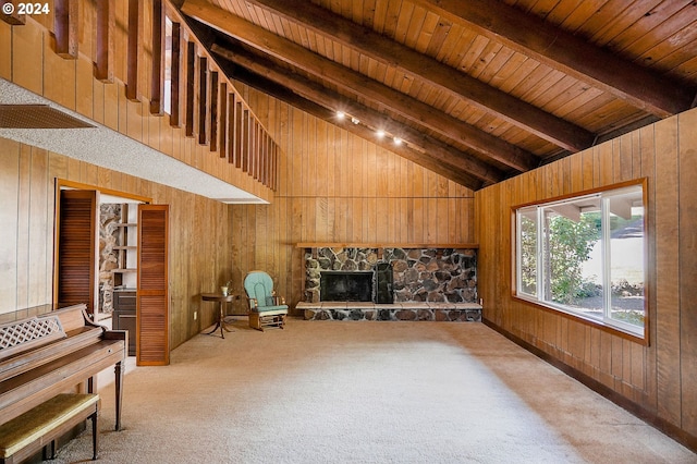 living room featuring wooden ceiling, a stone fireplace, wooden walls, and light carpet