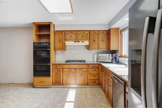 kitchen with light tile patterned floors, appliances with stainless steel finishes, backsplash, and sink